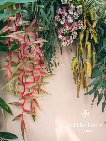 A close-up of the tropical flowers used in the 'Garden of Gaia' design, including heliconia and ginger blooms.