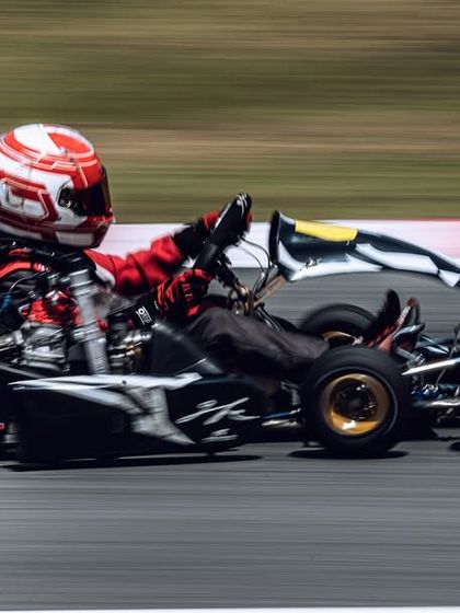 Our driver in a black and red kart during the RMC Asia Trophy, showing speed and commitment in his international debut.