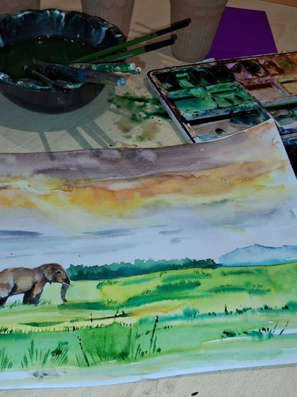 This watercolor landscape, featuring an elephant in a grassy field, shows the beautiful layering effects possible with this medium. Our workstation is always ready for the next artist.