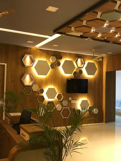 The reception area of this skincare clinic was designed to feel modern, clean, and welcoming. The backlit hexagonal panels on a wood-textured wall create a dynamic focal point, reflecting a brand that is both scientific and natural.