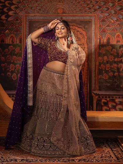 A candid shot that captures the joy of wearing a beautiful outfit. This lehenga is not just clothing; it's a part of your celebration. The detailed craftsmanship is visible in every part of the design.