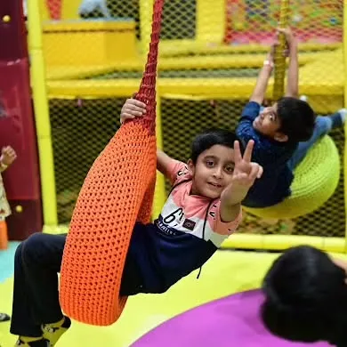 These boys are having a great time on our colorful swings. The soft play area has a variety of swings and structures to explore.