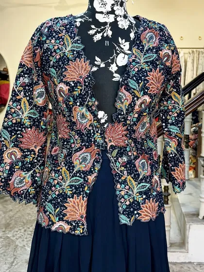 Another angle of the floral jacket set. The colors are vibrant and perfect for a festive occasion.