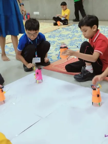 It's robot race day! After building their own scribbling bots from scratch, students get to see their creations come to life, drawing unique patterns as they zoom around.
