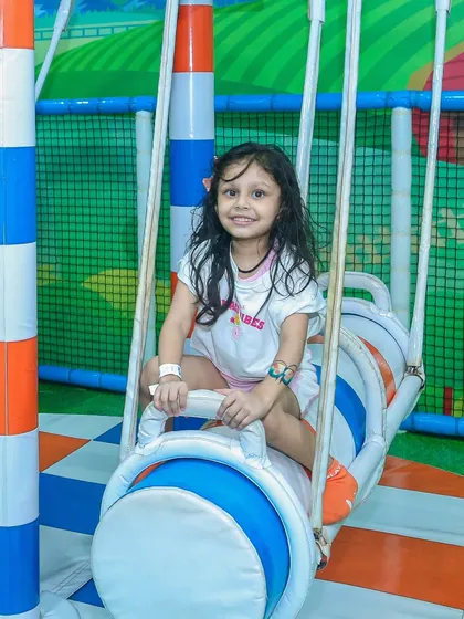 A sweet smile from a little girl enjoying one of our gentle swinging rides.
