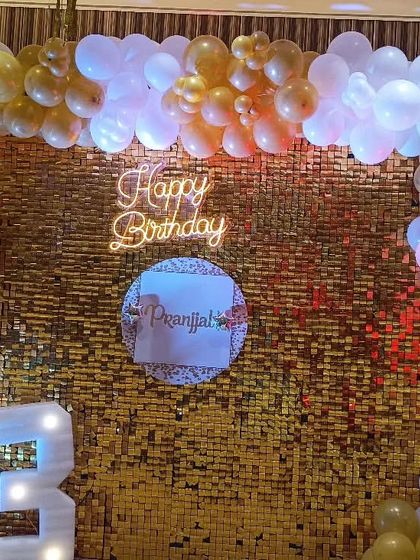 A trendy setup for a 13th "Golden Birthday" party. The focal point is a gold shimmer wall with a neon sign, framed by a balloon arch and a light-up "13" for a fun, photo-ready look.
