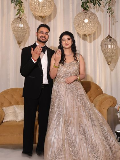 The happy couple showing off their rings. Her makeup is soft and pretty, perfect for the occasion.