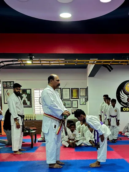 A young student bows respectfully as he receives his new belt. This simple act is a powerful symbol of the humility and gratitude we instill in our students as they progress.