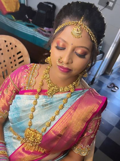 A close-up of Inchara's eye makeup, which features a blend of pink and gold tones to match her vibrant saree.