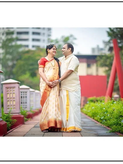 A beautiful portrait of a couple in traditional South Indian attire, walking together in a park.