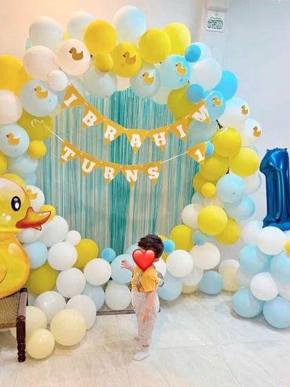 A cute "rubber ducky" theme for a first birthday. We created a cheerful backdrop with a blue and yellow balloon arch, a personalized banner, and a giant ducky prop for the little one.