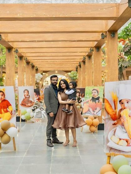 A beautiful family portrait in the woodland party's entrance walkway, which is lined with adorable photos of the birthday boy from his first year.