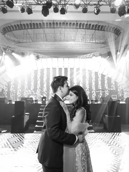 The same romantic first dance, in timeless black and white. This emphasizes the emotion and the beautiful stage lighting.