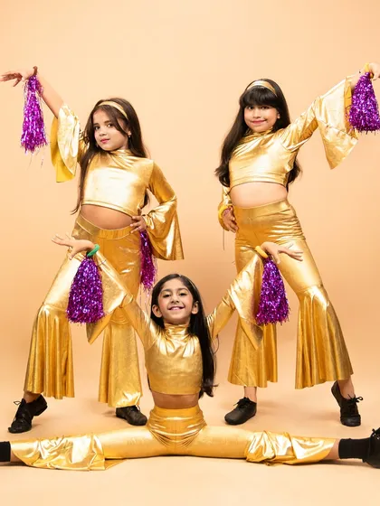 Our disco stars shine bright in this group photo. The smiles on their faces say it all. Our classes are about performance, but also about having the time of your life.