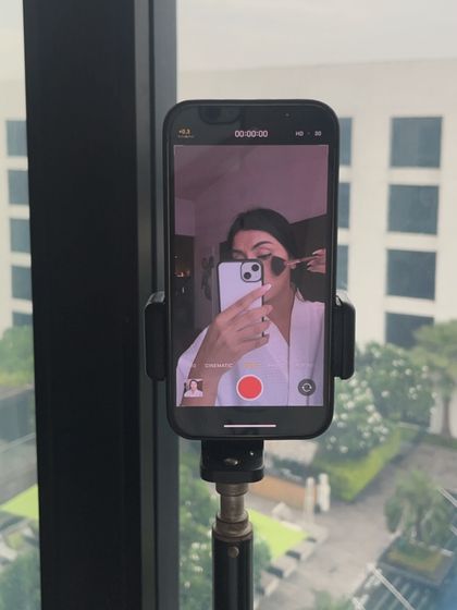 A behind-the-scenes shot of my setup for filming a makeup reel in my hotel room.