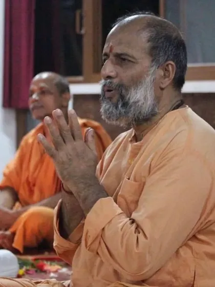 Leading the chanting during satsang. The vibrations of the mantras help to purify the mind and elevate the spirit, bringing the group together in a shared state of devotion.