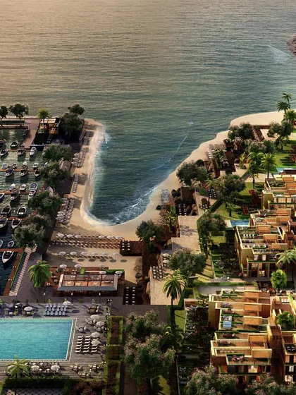 An aerial 3D visualization of a sprawling coastal villa community and marina. This bird's-eye view captures the full scope of the development, including the layout of the residences, the poolside amenities, and the arrangement of boats in the harbor, providing a comprehensive overview for potential investors.