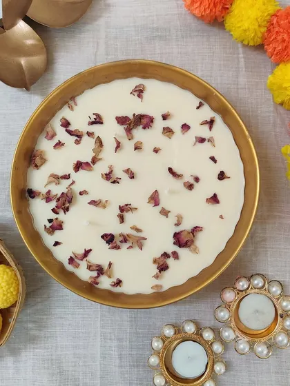 A top-down view of our rose petal candle bowl, surrounded by festive marigolds. This is the perfect gift to give friends and family during the festive season.