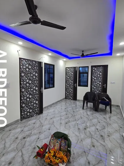 The interior of a completed rooftop room, featuring marble-finish flooring and a false ceiling with striking blue LED accent lighting. This shows we deliver fully finished, ready-to-use spaces.