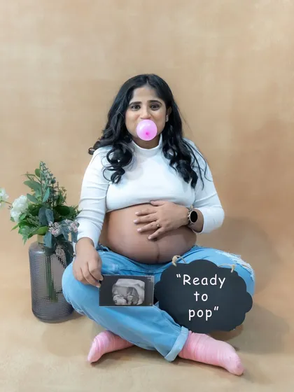 Let's have some fun. This casual studio portrait shows the playful side of pregnancy. We love incorporating personal touches like your ultrasound photo and fun props to make your session uniquely yours.