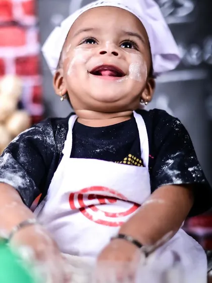 Meet the world's cutest little chef. Themed sessions like this are my specialty, and I provide all the props and costumes. We had so much fun with this messy, flour-dusted shoot, capturing this little one's pure, uninhibited joy.