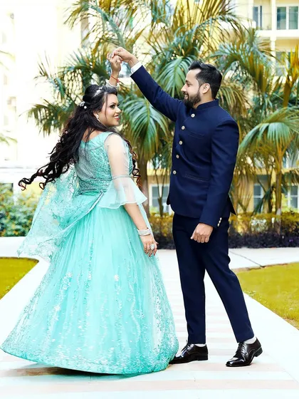 The groom twirls his bride-to-be in a joyful dance. This action shot captures the fun and excitement of their engagement day.