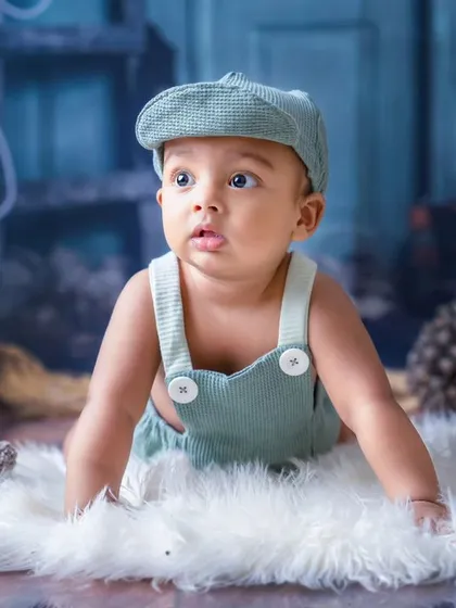 A little joy on the move. This crawling baby boy in his cute overalls is full of curiosity and wonder.