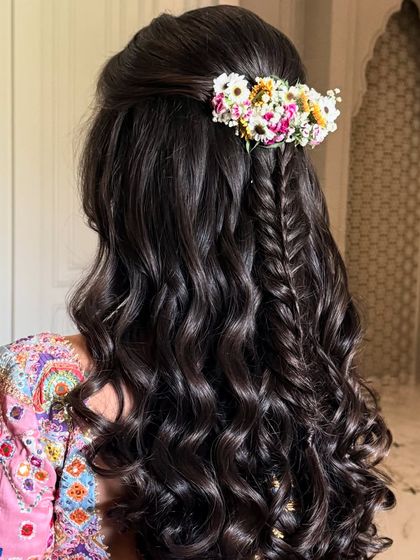 A side view of the floral fishtail half-up style, showing the texture and colors.