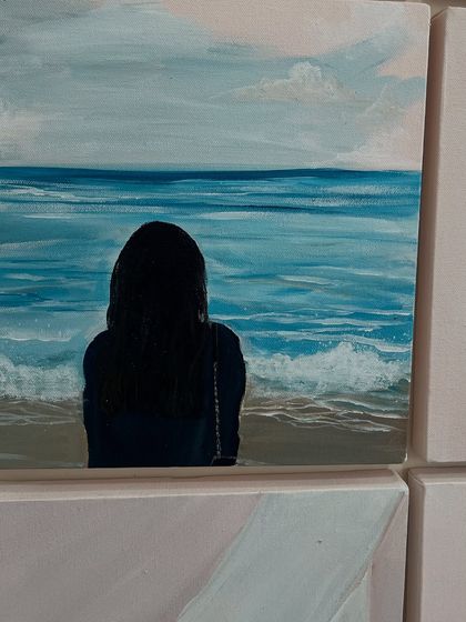 A serene moment by the sea, painted on a small canvas. This piece adds a sense of calm and introspection to the gallery wall collection.