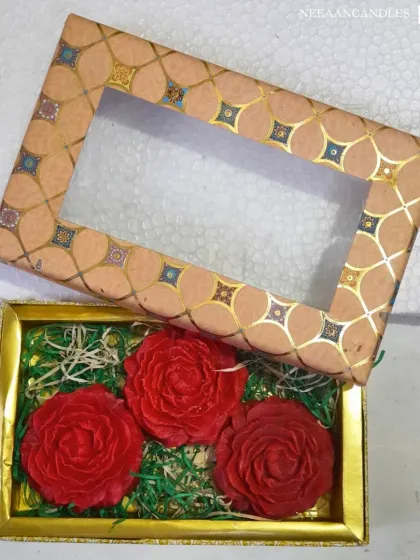 Our luxury rose candles, beautifully packed in a gift box. Three vibrant red rose-shaped candles are set on a bed of green, making a perfect choice for Diwali gifting.