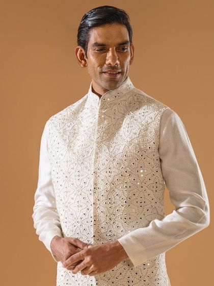 A close-up of the ivory Jawahar jacket with mirror work, capturing the smile of the wearer. The piece radiates grace and is perfect for any special occasion.