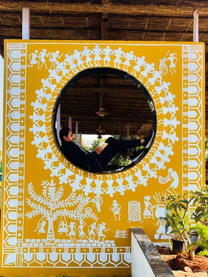 I gave this hut a modern twist with traditional Warli art. The bright yellow background and white figures create a striking photo-op spot, blending folk art with contemporary design.