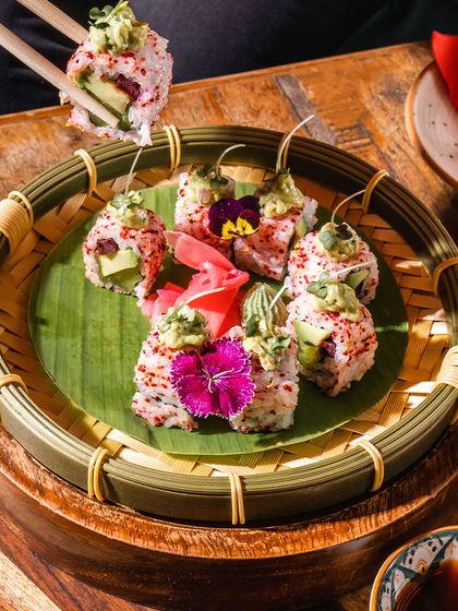 Our sushi is a work of art. This beautifully presented roll, topped with fresh avocado and edible flowers, showcases our commitment to creating dishes that are as beautiful as they are delicious.