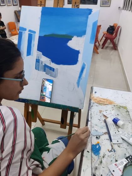 A series of images showing the progression of an acrylic seascape painting, from the initial blocking of colors to the addition of fine details.