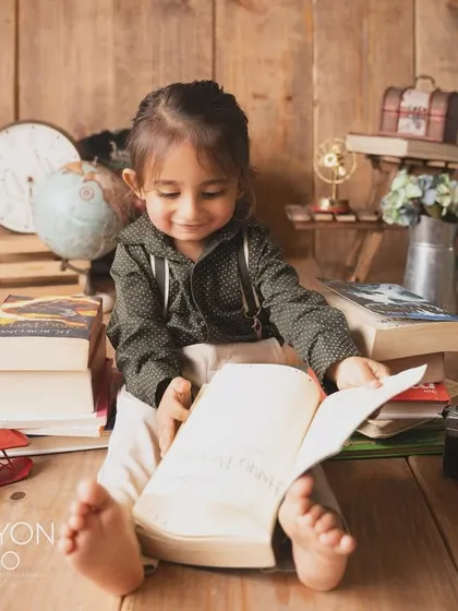 Lost in a story. This little one is engrossed in a book, a beautiful, quiet moment during his themed session.