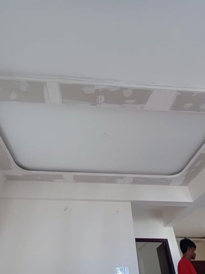 This image shows the initial stage of a false ceiling installation. Our team has created the framework and is preparing the surface for the final plastering and lighting fixtures.