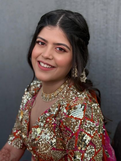 A close-up portrait of the bride, her smile infectious. The pop of pink on her eyes adds a fun and youthful touch to her glam.