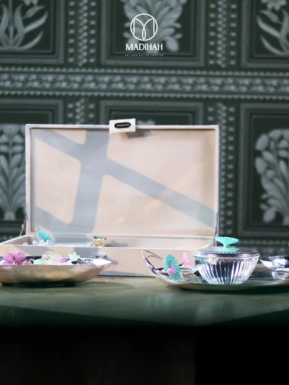 The Daisy Collection set against a traditional Indian-motif wallpaper, highlighting how our designs blend heritage with modern aesthetics. This is a timeless gift for the festive season.