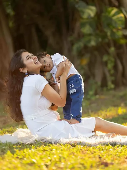 A tender moment between mother and child during an outdoor session, filled with natural light and genuine emotion.