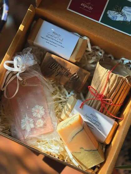 A closer look inside the Divinity Gift Box, showing the Sandalwood Vanilla and Jasmine Lemongrass soaps nestled with a wax sachet.