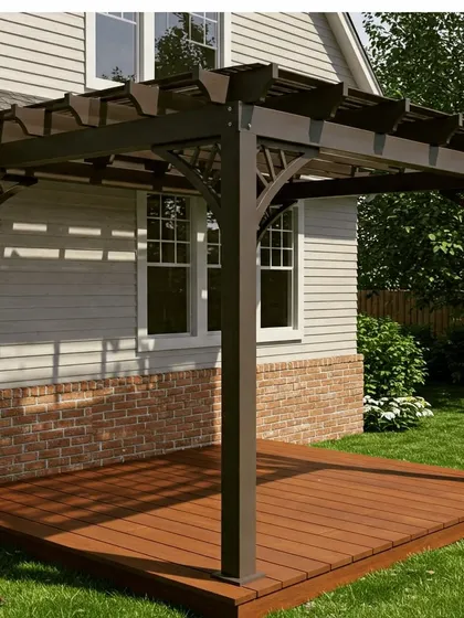 A traditional dark brown pergola with decorative corner braces, installed on a wooden deck. The design complements the classic architecture of the adjacent house.