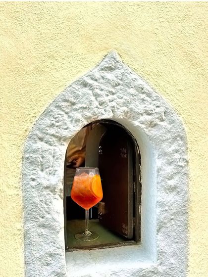 When life gives you an Aperol Spritz, you take it. This beautiful shot captures the golden hour glow in a glass.