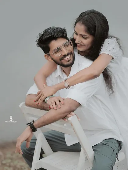 A joyful hug from behind. This close-up captures their genuine smiles and affection for one another.