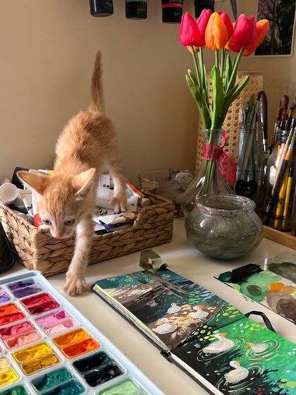 My cute little helper, a ginger kitten, exploring my desk while I work on the duck painting. He loves to supervise my work.
