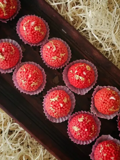 A tray of freshly made Motichoor Ladoo candles, each topped with delicate gold flakes. They look almost good enough to eat and are a perfect, unique gift for Diwali.