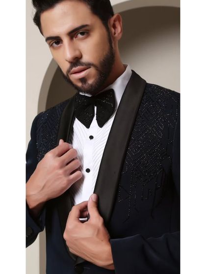 A close-up of the Prism Riviera tuxedo, focusing on the intricate geometric beadwork and the sparkling texture of the custom bow tie. Every element is designed to work in harmony.