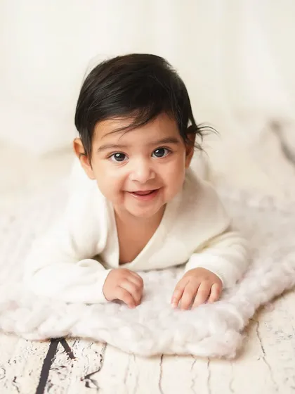 A happy baby boy during his tummy time session. This is a great milestone to capture when they have strong head and neck control.