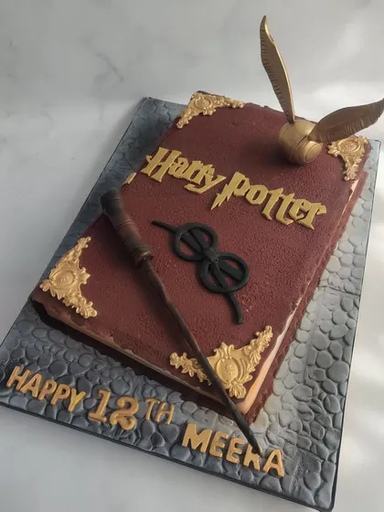 I love a creative challenge, and this sculpted Harry Potter book cake was a joy to make. Every detail, from the golden snitch to the edible wand, is designed to transport you to a world of magic for a truly spellbinding birthday.