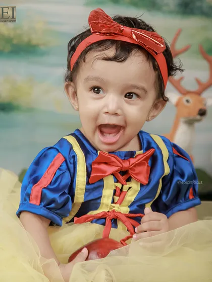A joyful, open-mouthed smile from our little Snow White. Her bright costume and happy expression make this a truly enchanting portrait.