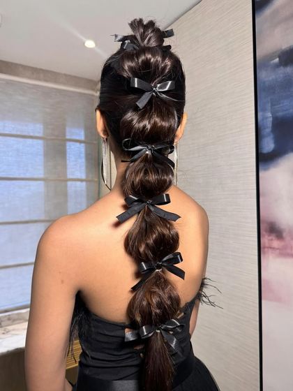 For a fun and fashion-forward look, I created this bubble braid and adorned each section with a delicate black bow. This is a great option for a cocktail party or bachelorette.